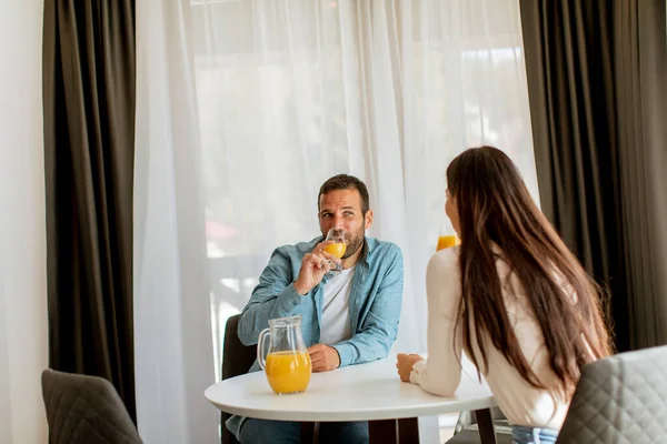 Jovem Casal Sala Estar Beber Suco Laranja — Fotografia de Stock