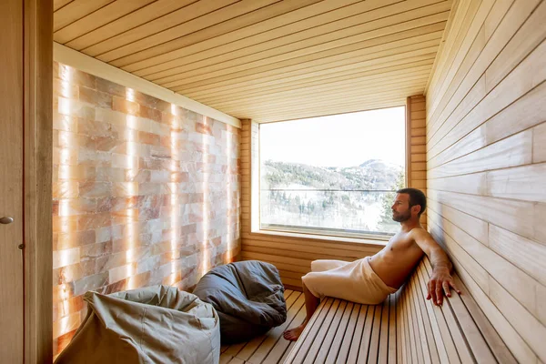 Joven Guapo Relajándose Sauna Viendo Bosque Invierno Través Ventana — Foto de Stock