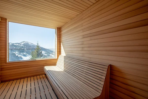 View at empty wooden sauna room with traditional sauna accessories