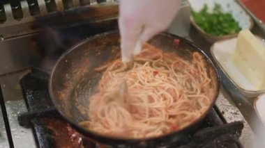 Aşçının fırında makarna hazırladığı yakın plan.