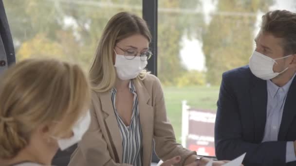 의사들이 회의를 사무실에서 일하며 코로나 바이러스로부터 보호하기 마스크를 — 비디오