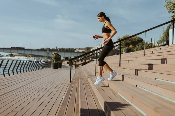 Spor Giyimli Güzel Bir Kadın Nehir Kenarında Egzersiz Yapıyor — Stok fotoğraf