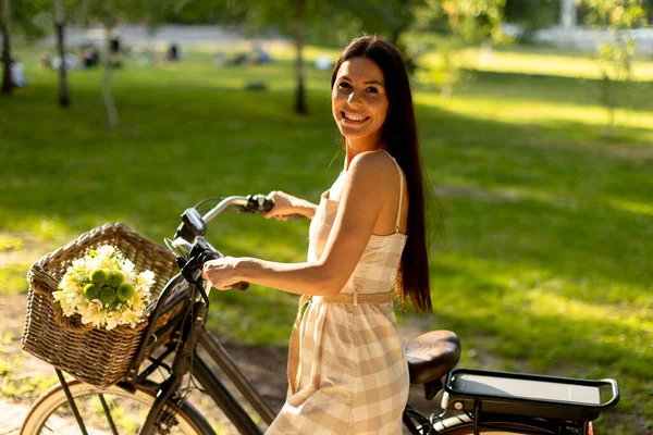 Bella Giovane Donna Con Fiori Nel Cestino Della Bici Elettrica — Foto Stock