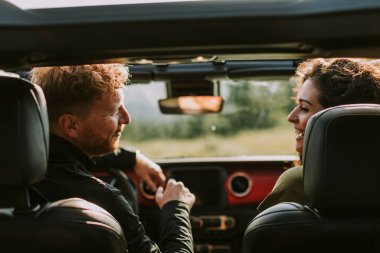 Young handsome couple having fun on roadtrip
