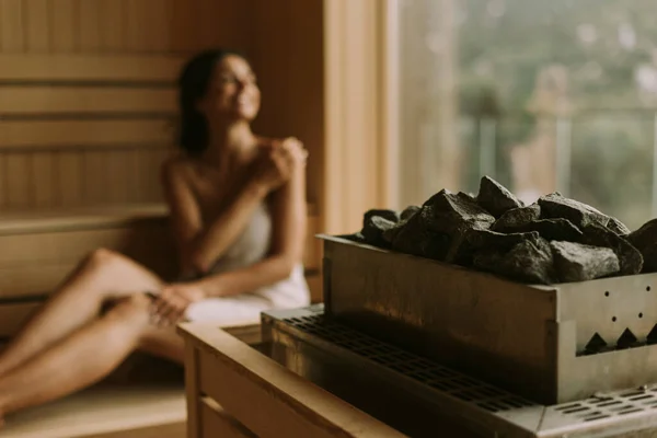 Attractive young woman relaxing in the sauna