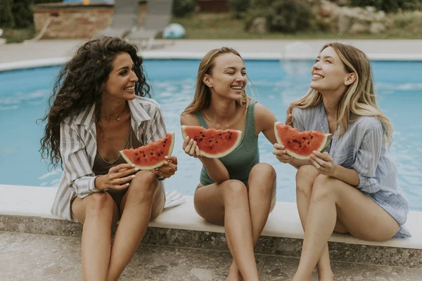 Three Cute Young Women Sitting Swimming Pool Eating Watermelon House — ストック写真