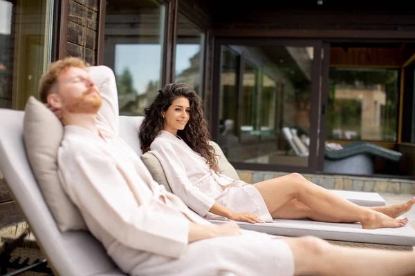 Handsome Young Couple Relaxing Beds Outdoor Terrace —  Fotos de Stock