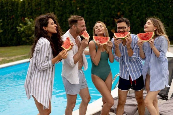 Group Young People Standing Swimming Pool Eating Watermelon House Backyard — Stock Photo, Image