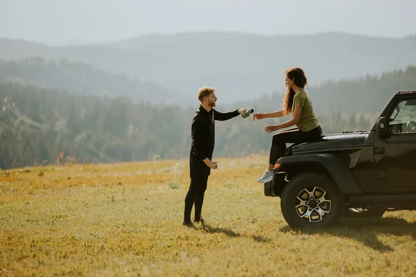 Smiling Young Couple Preparing Hiking Adventure Backpacks Terrain Vehicle — Foto de Stock