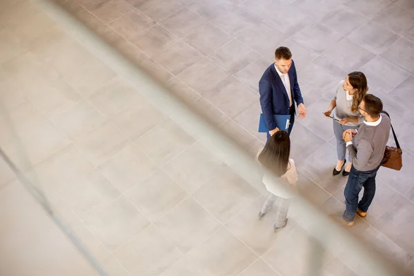 Aerial view at young business people team discussing in the office hallway