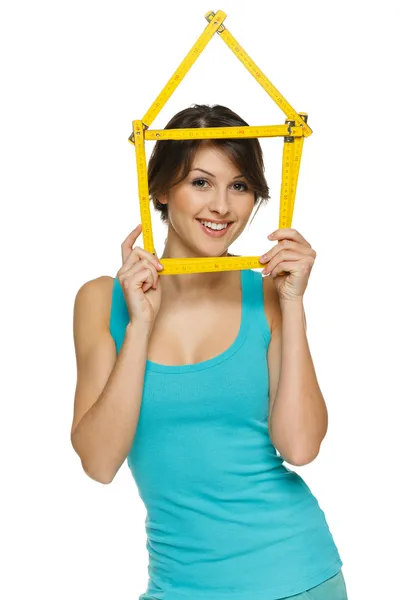 Woman looking through the house frame — Stock Photo, Image