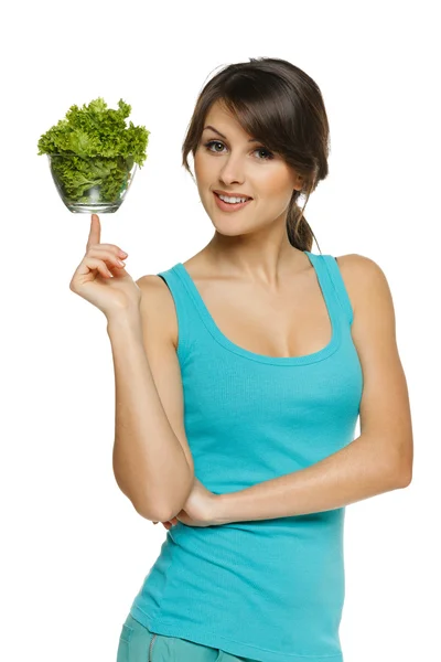 Woman balancing bowl with salad on her finger — Stock Photo, Image