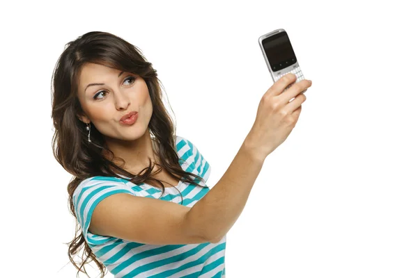 Girl giving kiss to cellphone Royalty Free Stock Images