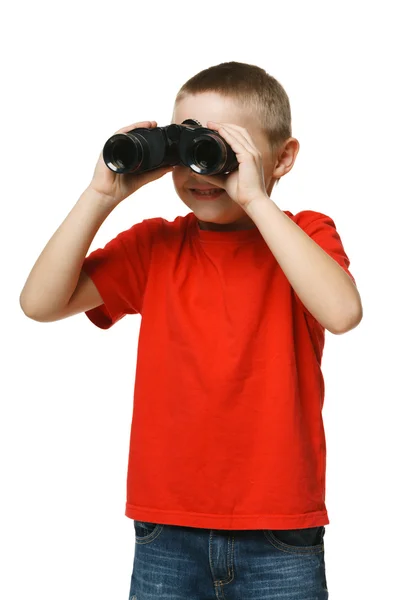 Zes jaar jongen op zoek weg via de verrekijker — Stockfoto