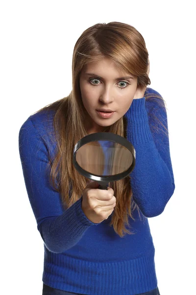 Girl looking through the magnifying glass — Stock Photo, Image