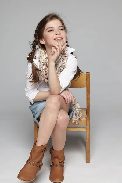 Little girl sitting on the chair — Stock Photo, Image