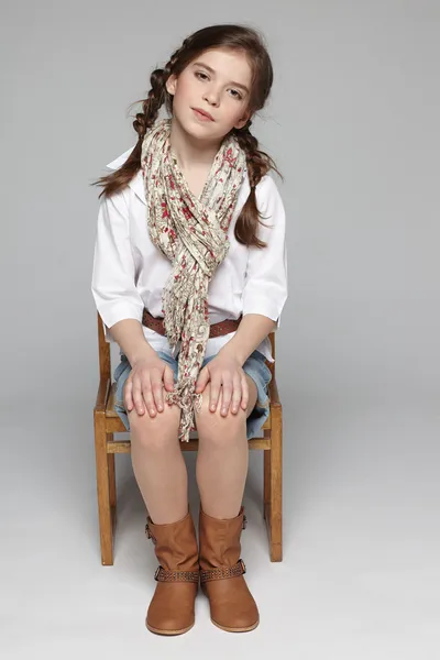 Little girl sitting on the chair — Stock Photo, Image