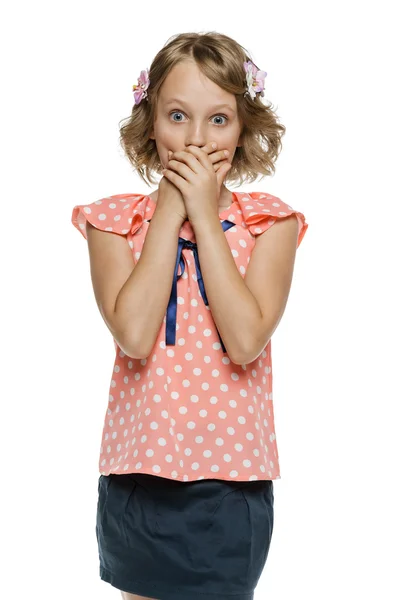 Girl standing with hands over mouth — Stock Photo, Image