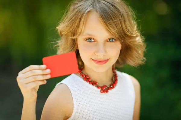Girl holding a blank credit card — Stock Photo, Image