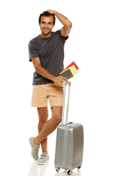 Young male tourist standing with silver travel suitcase — Stock Photo, Image