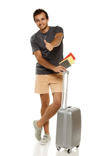 Young male tourist standing with silver travel suitcase — Stock Photo, Image