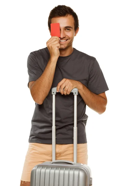 Young male with suitcase, holding empty credit card — Stock Photo, Image