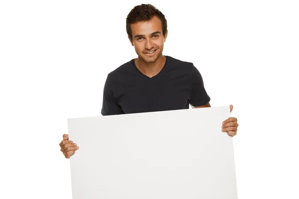 Young man holding blank banner — Stock Photo, Image