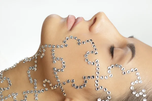 Female with beauty crystal puzzle on her face — Stock Photo, Image