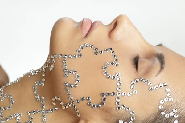 Female with beauty crystal puzzle on her face — Stock Photo, Image