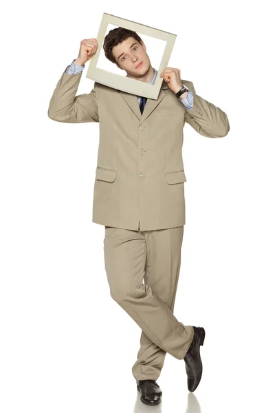 Young businessman looking through the TV — Stock Photo, Image