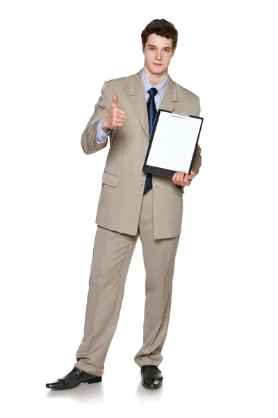 Full length of young businessman holding blank whiteboard showing thumb up gesture — Stock Photo, Image