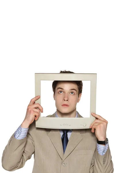 Surprised young businessman looking up through the TV — Stock Photo, Image