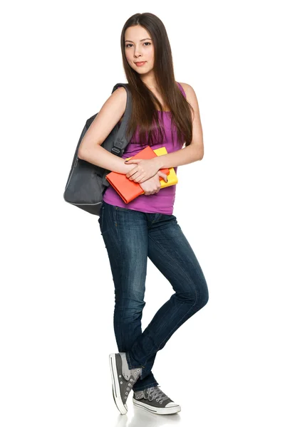 Lány visel a hátizsák és a gazdaság könyvek — Stock Fotó