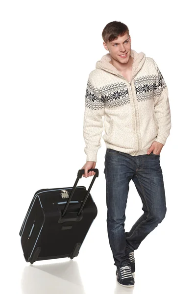 Man in full lenght standing with suitcase looking out of frame — Stock Photo, Image