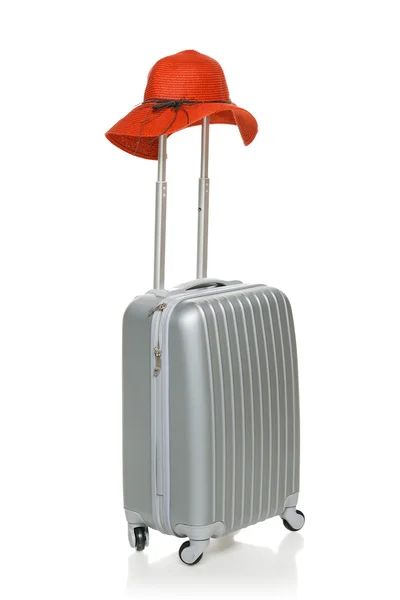 Silver suitcase with red straw hat — Stock Photo, Image