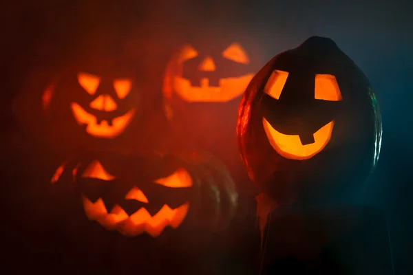 Four scary Halloween Pumpkin glowing in the dark — Stock Photo, Image