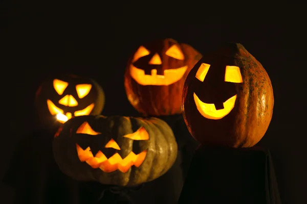 Four scary Halloween Pumpkin glowing in the dark — Stock Photo, Image