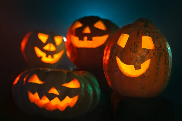 Four scary Halloween Pumpkin glowing in the dark — Stock Photo, Image