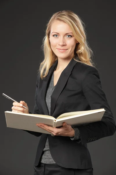 Женщина в костюме с книгой — стоковое фото