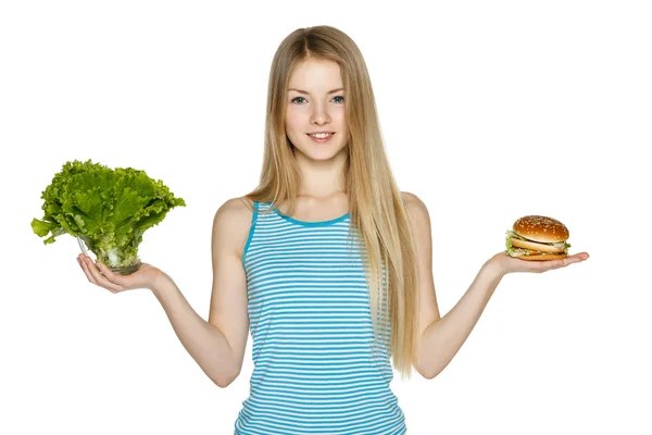 Woman making decision between healthy salad and fast food — Stock Photo, Image
