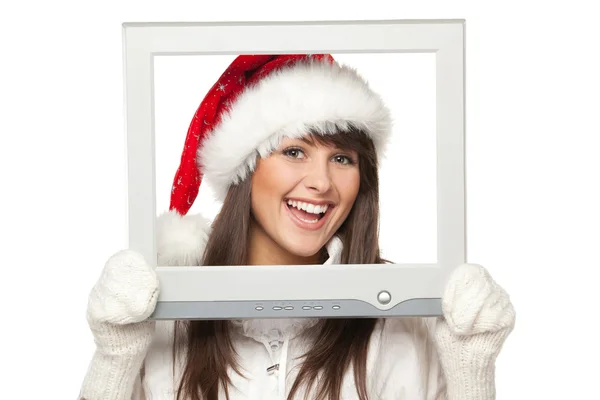 Flicka i santa hatt sänder jul nyheter från tv eller dator skärm — Stockfoto