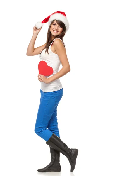 Chica con sombrero de Santa sosteniendo la forma del corazón —  Fotos de Stock