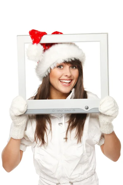 在圣诞老人的帽子从电视或电脑屏幕广播圣诞新闻中的女孩 — 图库照片