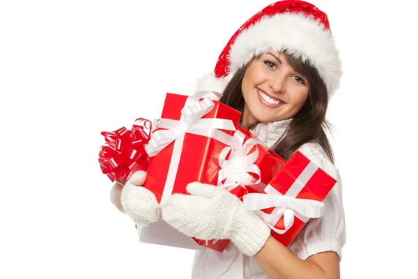 Woman holding gifts wearing red Santa hat — Stock Photo, Image