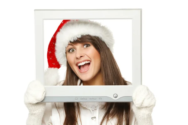 Mädchen mit Weihnachtsmütze überträgt Weihnachtsnachrichten vom Fernseher oder Computerbildschirm — Stockfoto