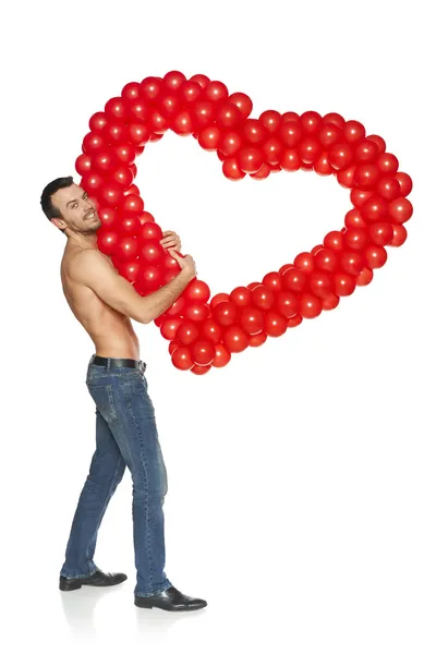 Hombre espiando a través de la forma del corazón — Foto de Stock