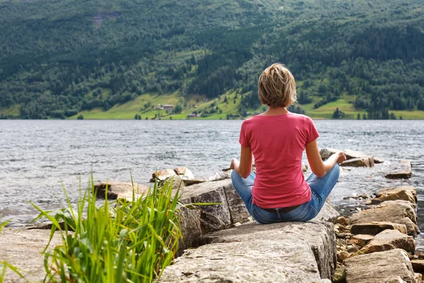 Femme relaxante au bord du lac — Photo