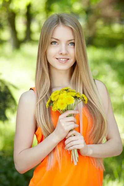Spring girl with bunch of dandelions — Stock Photo, Image