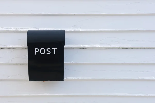 Boîte aux lettres noire sur mur en bois blanc de la maison — Photo