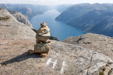 Stack of rocks with mountain and fjord view clipart